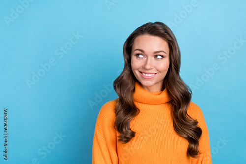 Photo of adorable thoughtful lady wear knitted pullover looking empty space isolated blue color background
