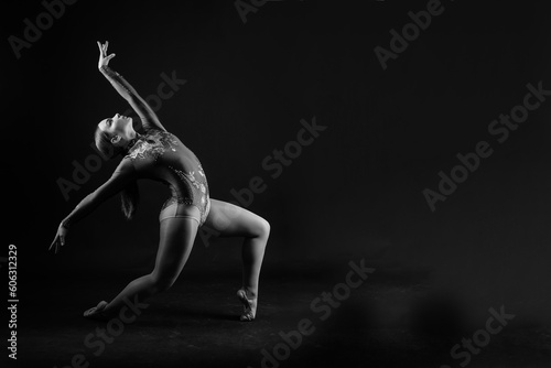 Beautiful cool young fit gymnast woman in sportswear dress working out, performing art gymnastics