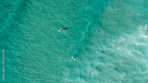 Aerial view of the ocean with surfers, wave and nice pristine blue water © FRPhotos