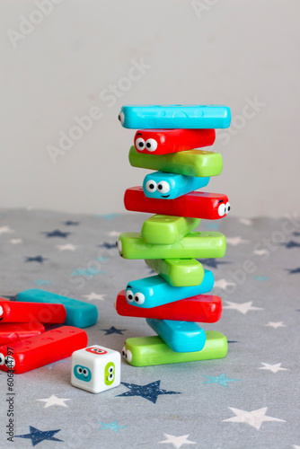 Classic children's game of colored plastic blocks, which consists of choosing a color, removing it and if you knock down the building, you lose. Known as Jenga or Kapla photo