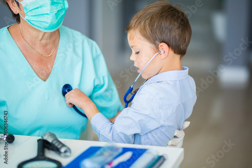 Little boy playing with a stethoscope