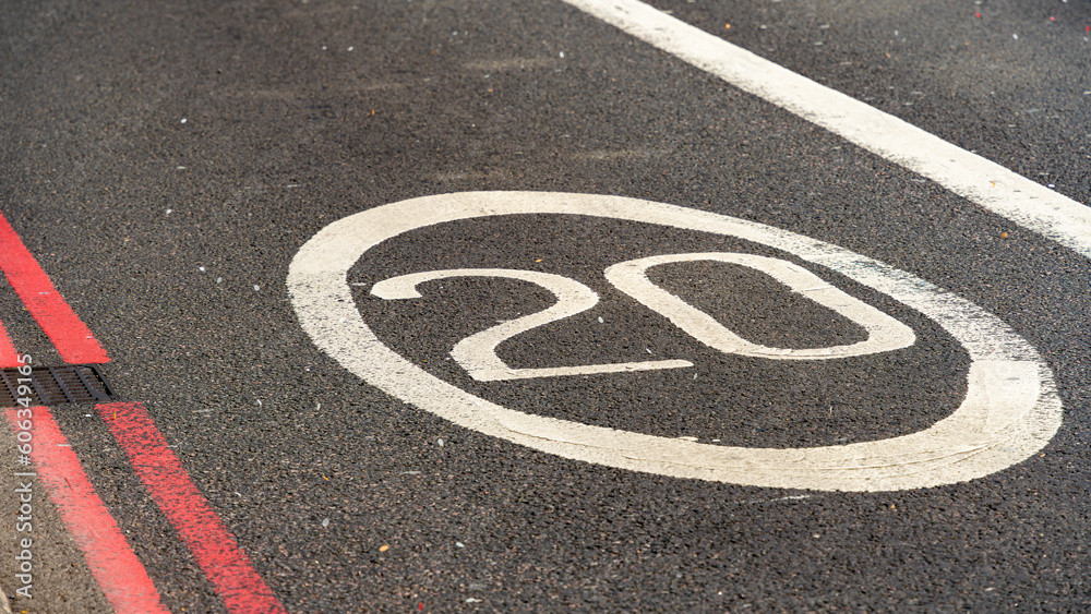 Fototapeta premium 20 mph speed limit painted on a road surface