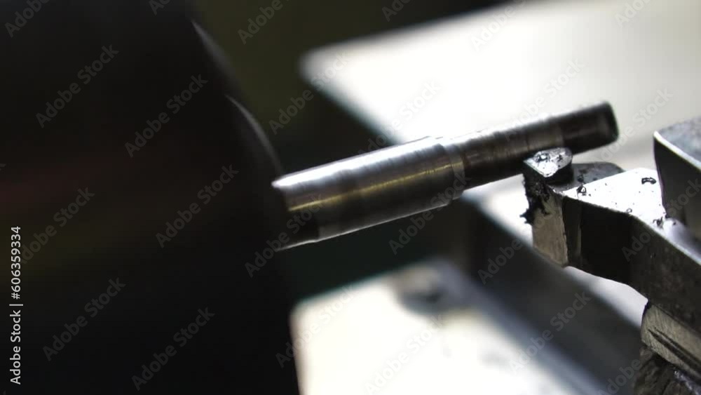 Close-up lathe machine operation by cutting the metal tube. vintage lathe machine tool operates with metal detail under mature worker control in old production plant workshop. Slow motion Close-up lathe machine operation by cutting the metal tube. vintage lathe machine tool operates with metal detail under mature worker control in old production plant workshop. Slow motion