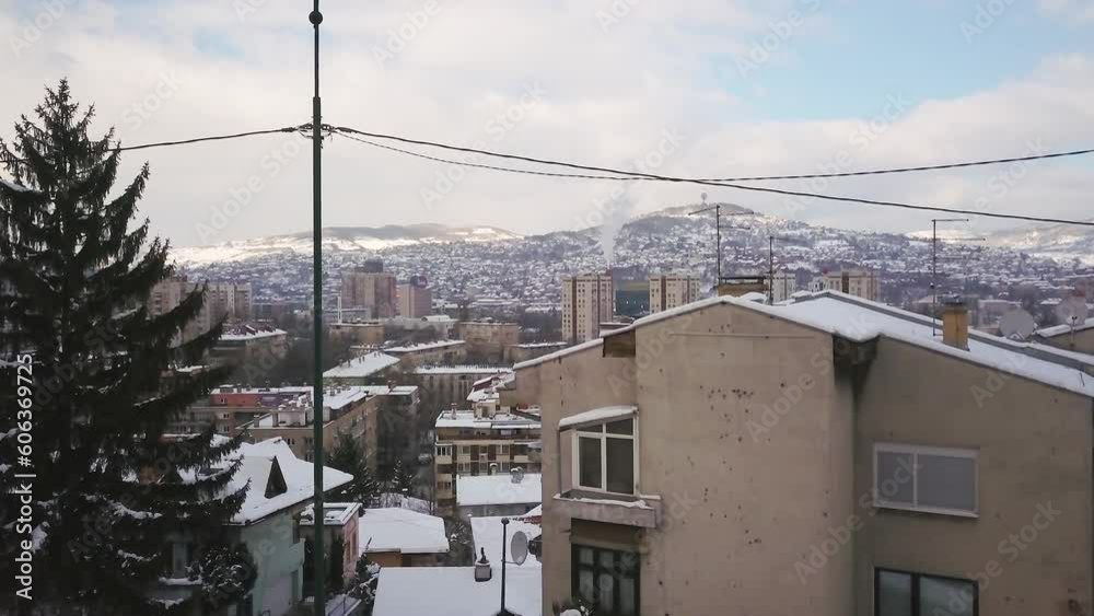 Aerial cinematic drone winter war zone bullet holes on buildings Olympic downtown snowy frozen Sarajevo City town center Bosnia and Herzegovina frozen landscape sunset slow upward movement Aerial cinematic drone winter war zone bullet holes on buildings Olympic downtown snowy frozen Sarajevo City town center Bosnia and Herzegovina frozen landscape sunset slow upward movement
