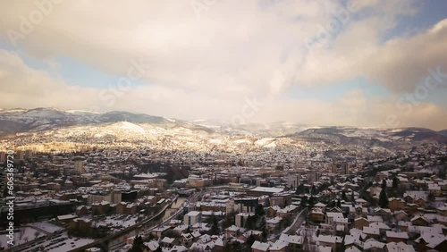 Aerial cinematic drone winter Olympic downtown snowy streets roads Sarajevo City center Avaz twist Bosnia and Herzegovina cars and highway frozen war ruins landscape sunset forward movement photo