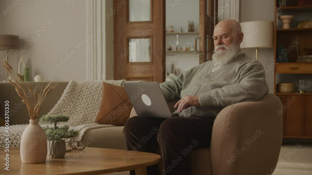 Grandfather Browsing on Laptop and Looking At Camera Laughing Grandfather Browsing on Laptop and Looking At Camera Laughing