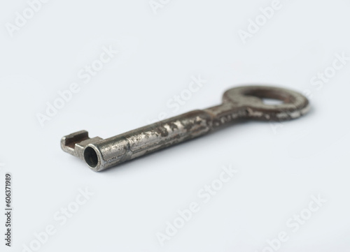 An old metal key on a white background