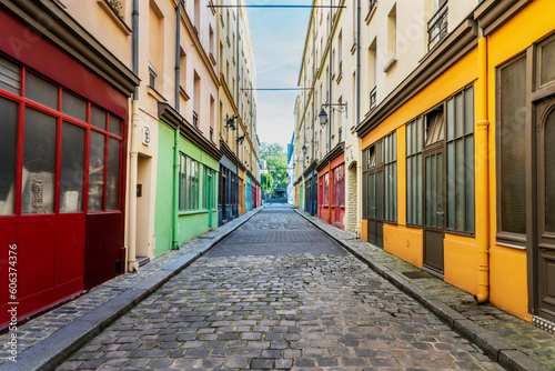 Fototapeta Naklejka Na Ścianę i Meble -  Vintage colorful workshops and art studios in a small cobblestone street in Paris, France
