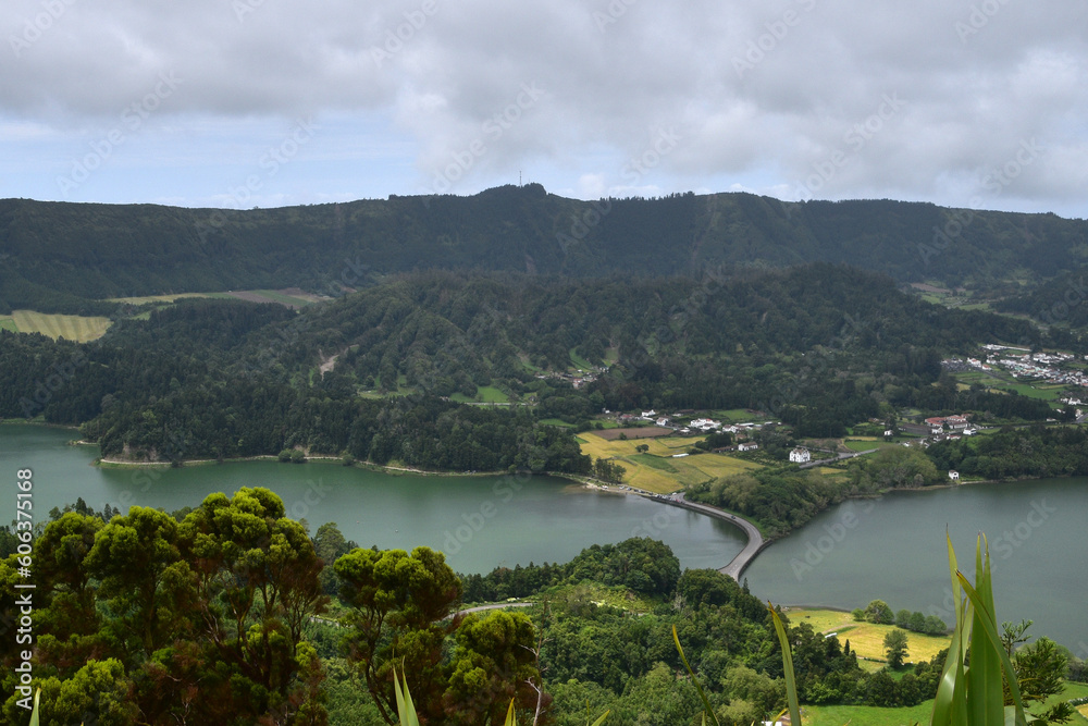 Fototapeta premium Scenic view of a big lake and mountains against sky