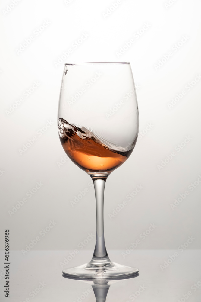Splash of wine in a glass, motion blur, frozen wine motion Splash of wine in a glass, motion blur, frozen wine motion