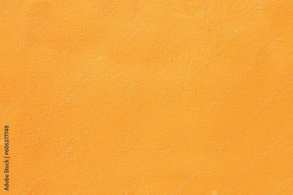 Abstract background of orange plaster on the wall. Surface of painted wall close-up. Abstract background of orange plaster on the wall. Surface of painted wall close-up.