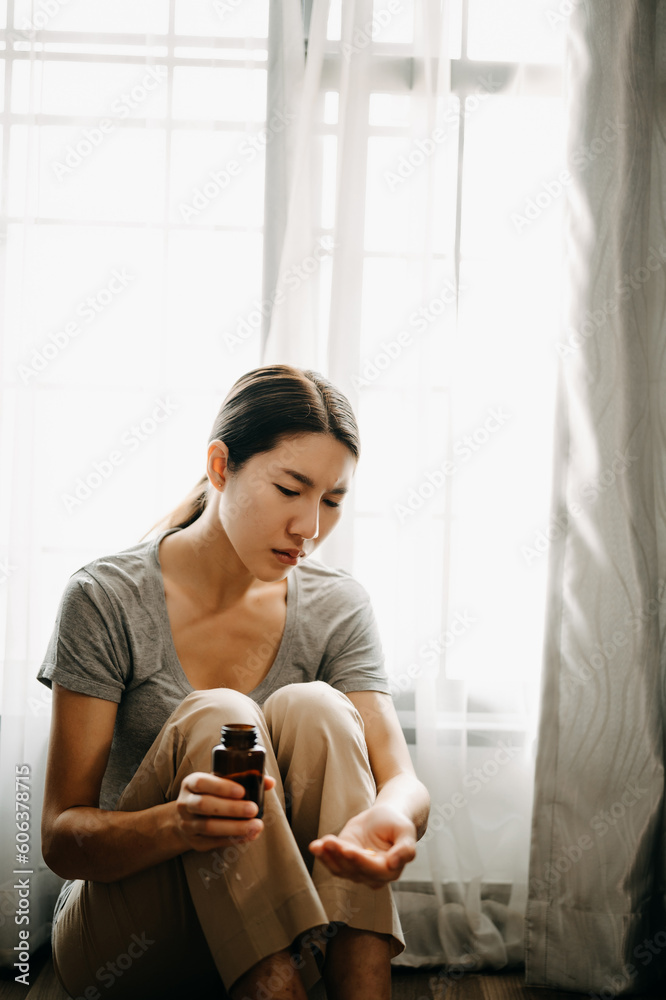 woman sit Depression Dark haired pensive glance Standing with glass of water and pills by window and anxiety Copy space. . woman sit Depression Dark haired pensive glance Standing with glass of water and pills by window and anxiety Copy space. .