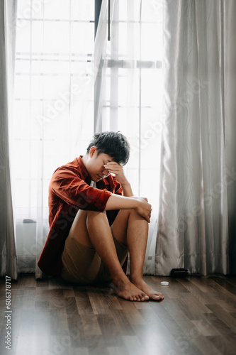 Wallpaper Mural Asian Man sit Depression Dark haired  pensive glance Standing by window and anxiety Copy space. Torontodigital.ca