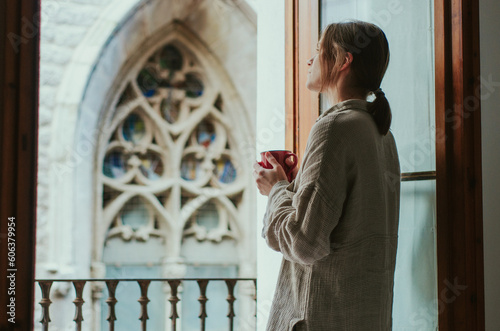 Canvas Print Woman enjoys a cup of tea while admiring the beautiful cathedral architecture fr