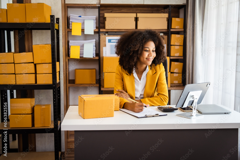 Φωτογραφία African American business woman working at warehouse preparing SME package box for delivery at small business home office