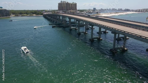 Destin William T. Marler Bridge on sunny day with boats in water, aerial flyover. Drone Shot over William T. Marler Bridge photo