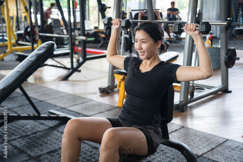Asian woman exercising at the gym.Fitness and wellness concept.