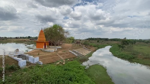 Unique landscape of Jharkhand with a beautiful yellow temple and a river and farm in the background. photo