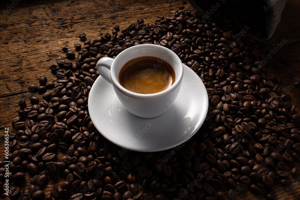 cup of coffee on top of coffee beans.