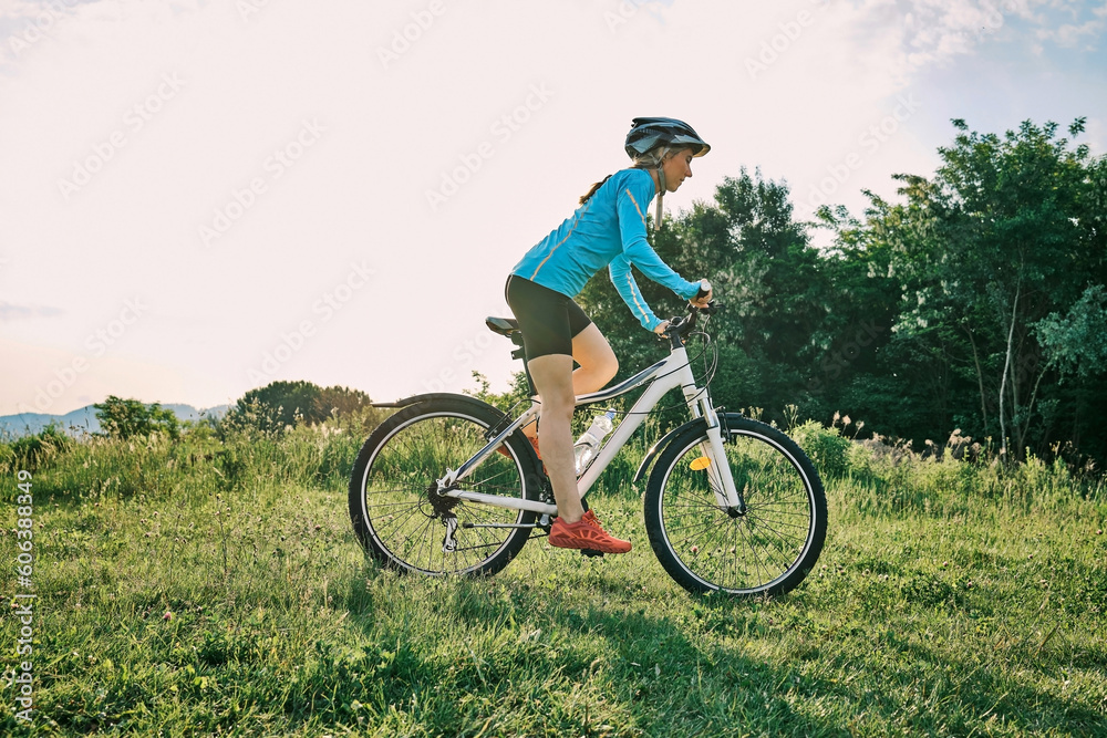 Cyclist Woman riding bike, sports outdoors on sunny day a mountain in the forest. Silhouette female at sunset. Health care, authenticity, sense of balance and calmness.
Cyclist Woman riding bike, sports outdoors on sunny day a mountain in the forest. Silhouette female at sunset. Health care, authenticity, sense of balance and calmness.