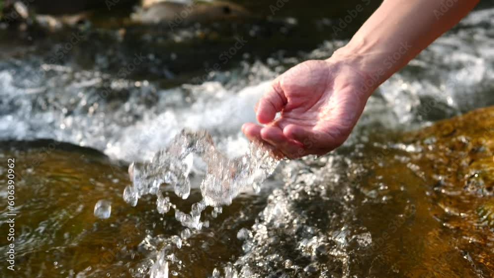 Hands touching water in nature water flows through the mountains, beautiful nature. Hands touching water in nature water flows through the mountains, beautiful nature.