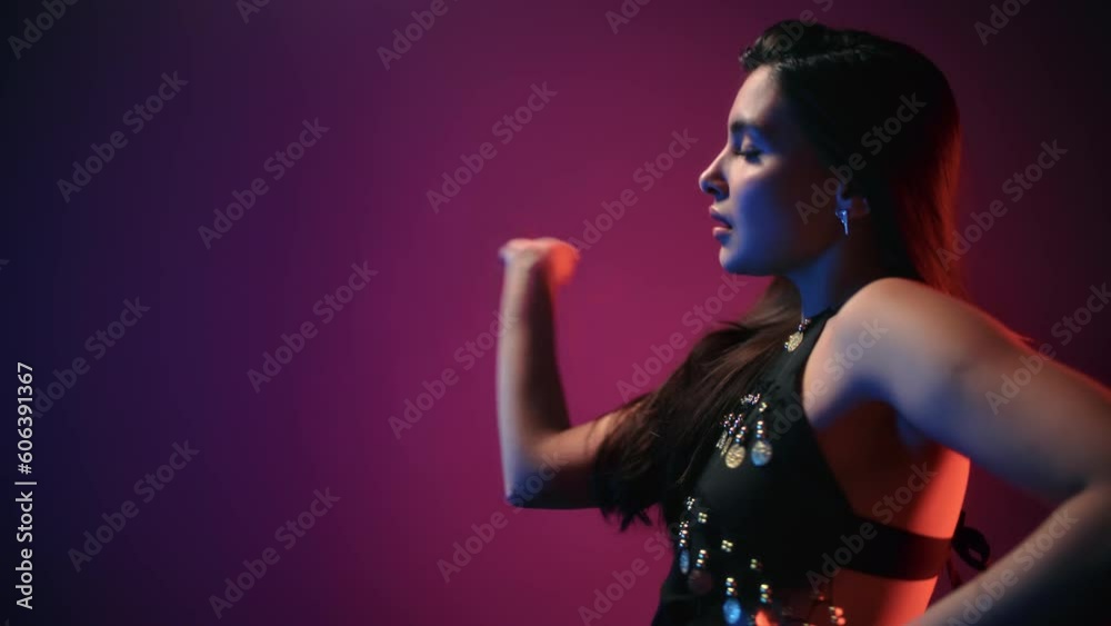Passion beautiful oriental brunette woman belly exotic dance flexible hand movement dark backlight