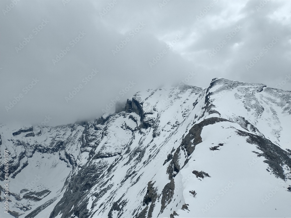 Beautiful view of a cloudy sky over the mountain covered in snow in Alberta, Canada. Beautiful view of a cloudy sky over the mountain covered in snow in Alberta, Canada.