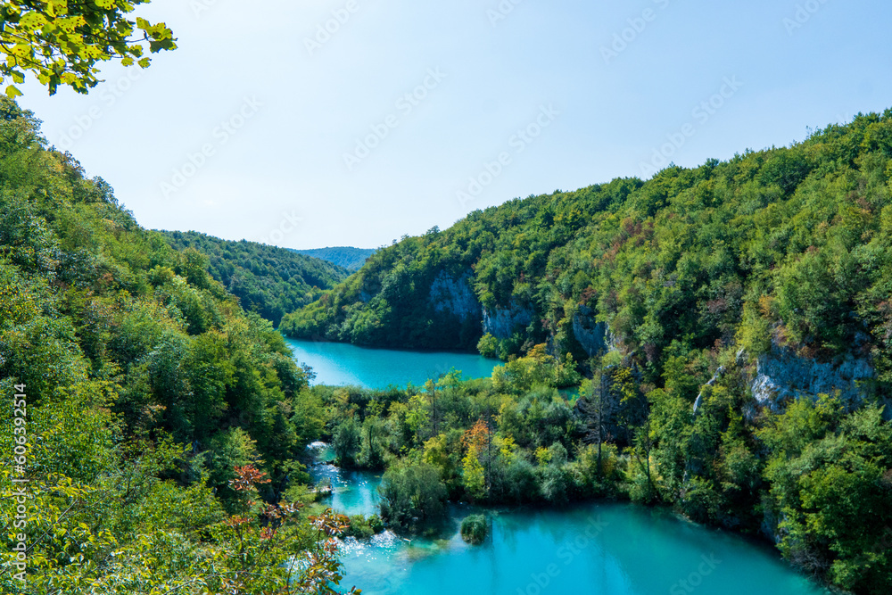 Plitvice, Croatia - Panoramic view of the beautiful waterfalls of Plitvice Lakes in Plitvice National Park on a bright summer day with blue sky and clouds and green foliage and turquoise water