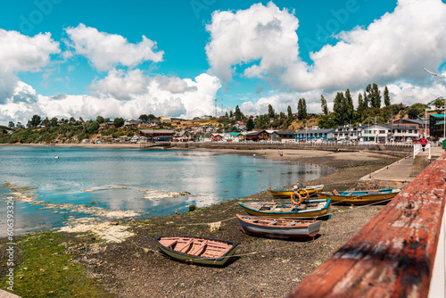 Scenic view of wooden boats and colorful houses on a shore of a lake in Chonchi, Chiloe, Chile photo