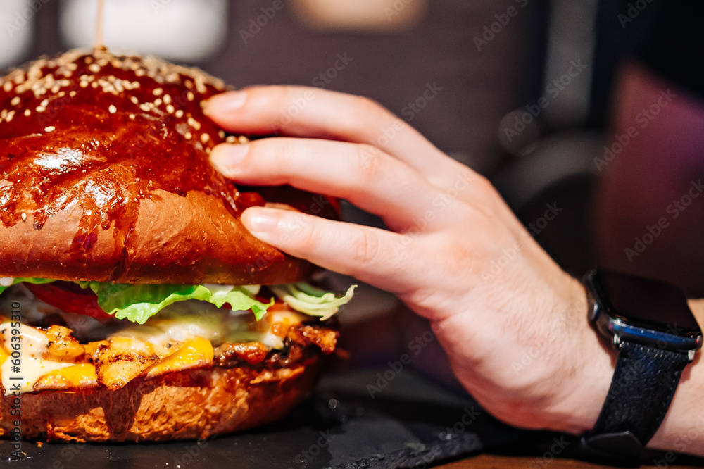 man hand hold very big large burger man hand hold very big large burger