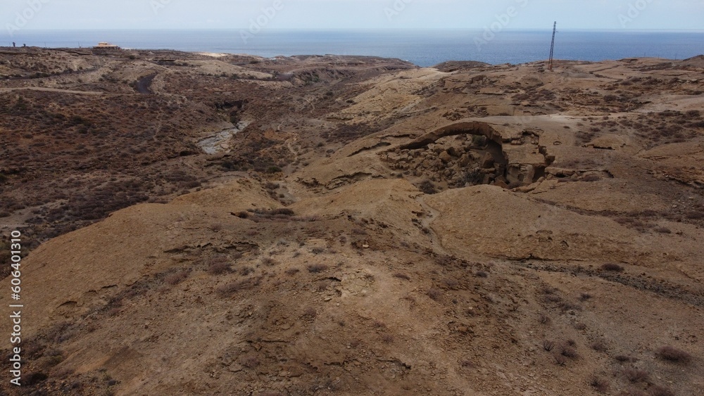 Aerial view of the Arco de Tajao formation in desert outside town Cala de Tajao