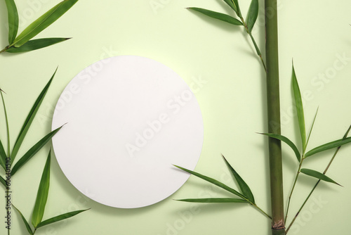 Natural cosmetic concept with bamboo tree and green leaves decorated around an empty white round podium. Stage showcase on pedestal © Tuan  Nguyen 