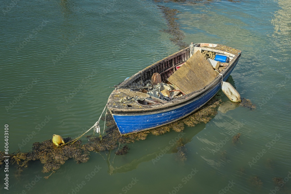 Old and abandoned boat in the dirty water