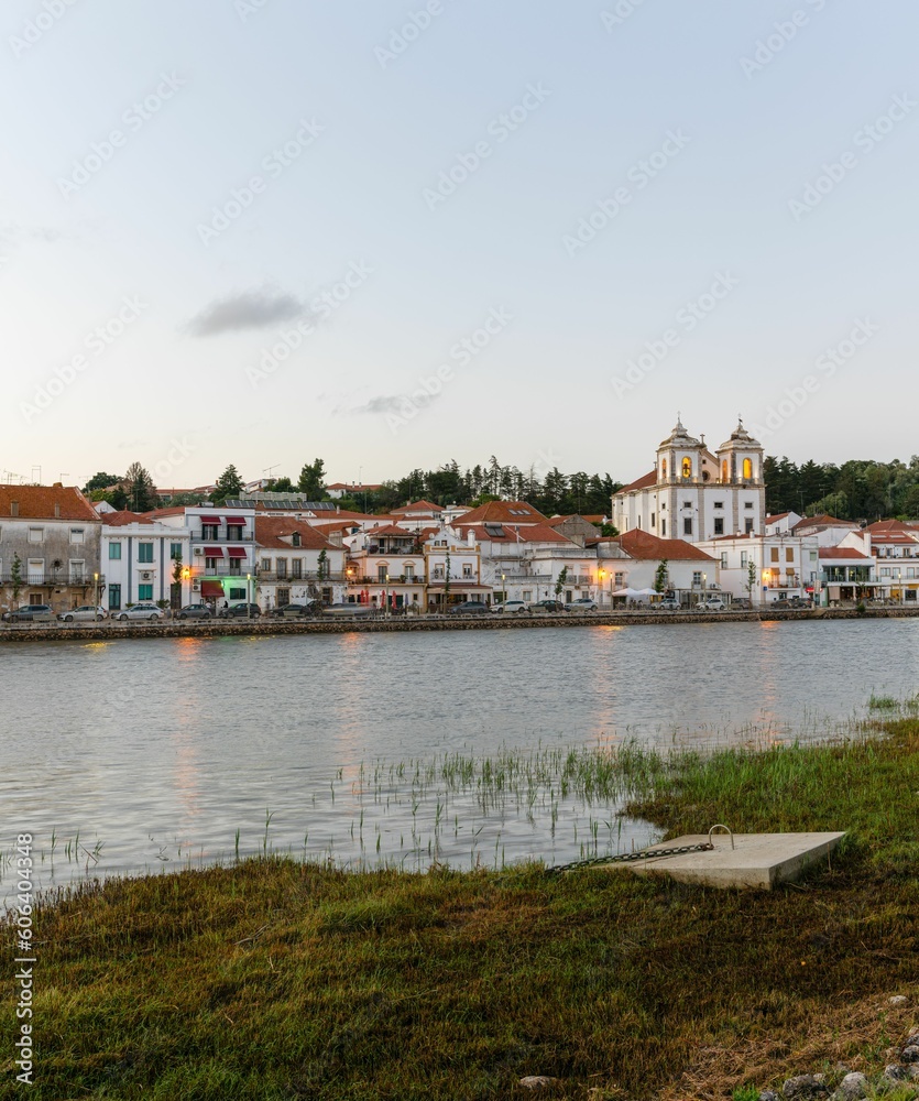 Beautiful landscape over the riverside area of Alcacer do Sal, Portugal with buildings on the shore Beautiful landscape over the riverside area of Alcacer do Sal, Portugal with buildings on the shore