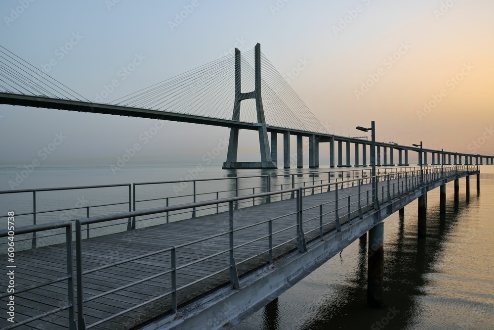 Mesmerizing sunrise view over the Vasco of Gama Bridge on the Tagus River in Lisbon, Portugal