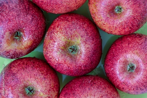 Top view of red apples of pero bravo esmolfe species washed with fresh water on a green plate photo