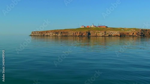 Close Snake Island against the backdrop of a calm sea, sunset lighting. Black Sea, Ukraine. photo