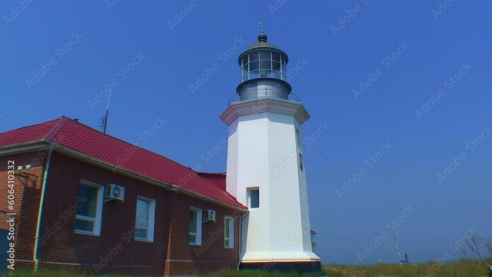 Snake Island lighthouse and lighthouse buildings, side view, wide shot. Black Sea, Ukraine. Snake Island lighthouse and lighthouse buildings, side view, wide shot. Black Sea, Ukraine.