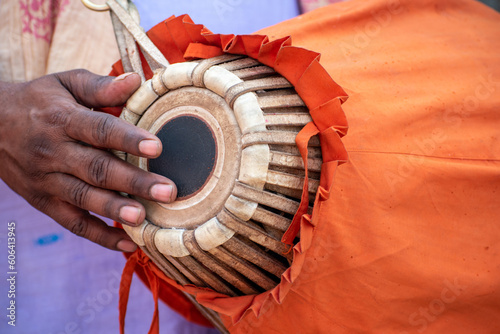 The khol is being played by a devotee. This is a two-sided terracotta drum used in northern and eastern India for accompaniment with devotional music is also known as a mridangam photo