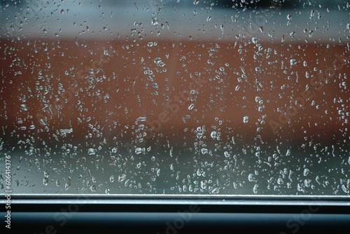 Droplets on the glass against the blurry background.