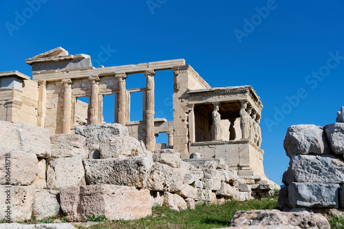 The ancient Parthenon temple in the Acropolis of Athens, Greece on a bright blue background. Remains of the building. Archaeological monument. Horizontal photo