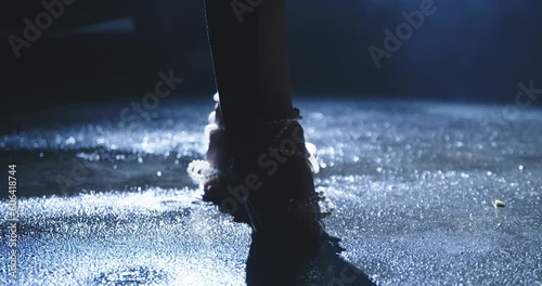 woman walking on wet street at night in high heels slow motion photo