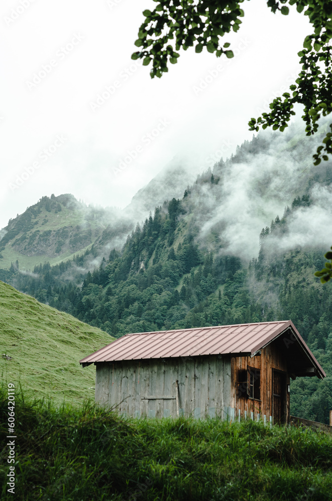 Vertical shot of a mountain hut in the mountains of Oytal, Obesrtdorf, Allgau, Bavaria, Germany Vertical shot of a mountain hut in the mountains of Oytal, Obesrtdorf, Allgau, Bavaria, Germany