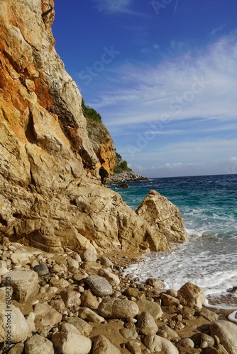 Scenic shot of a rocky hidden beach near a cliff