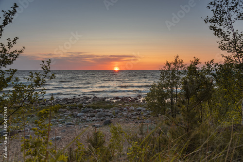 Sunset on the Baltic sea beach full of rocks at Vidzeme, Latvia.
