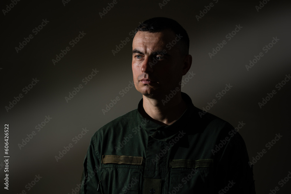 Portrait of military man in olive uniform seriously looking forward Portrait of military man in olive uniform seriously looking forward