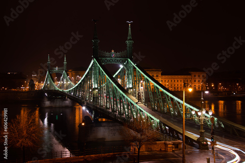 green bridge in city by night