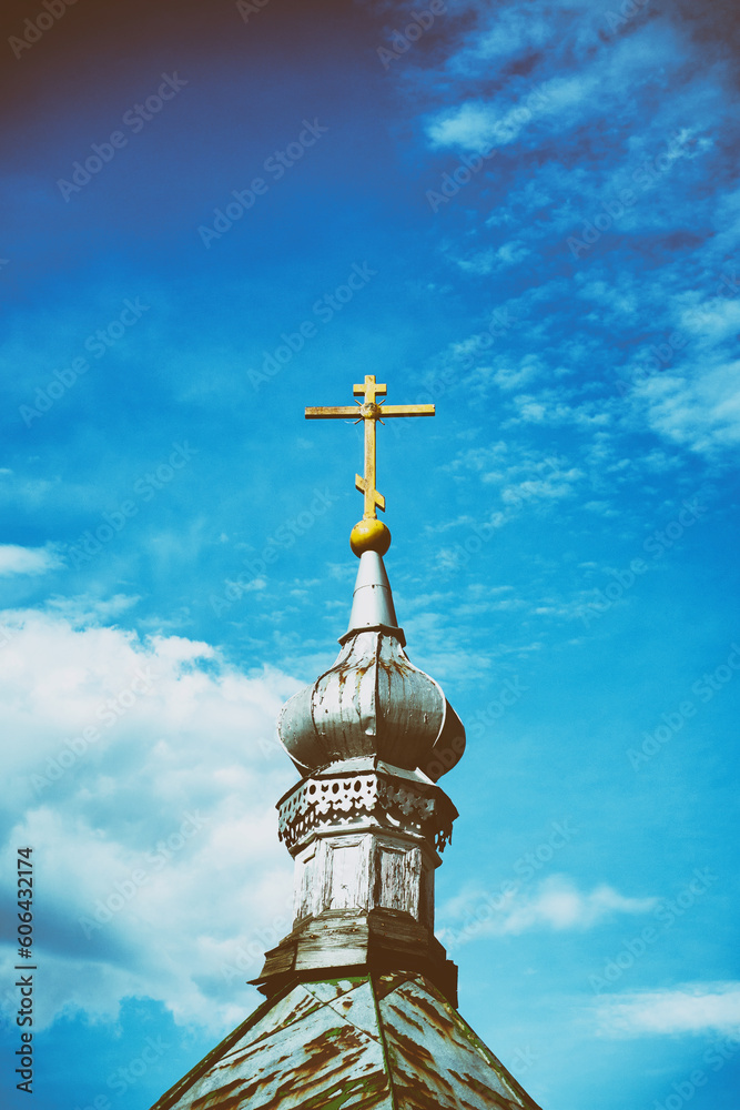Cross on top of old orthodox church against blue sky. Vintage camera effect on image Cross on top of old orthodox church against blue sky. Vintage camera effect on image