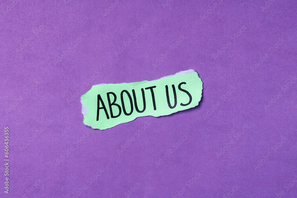 Word About Us written on torn paper isolated over purple background with copy space.