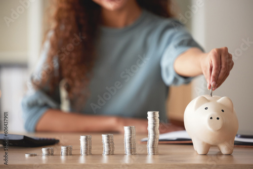 Woman, hand and money savings in piggy bank, finance and budget, future financial planning with investment and coins on table. Female person saving, economy with growth and coin currency in container